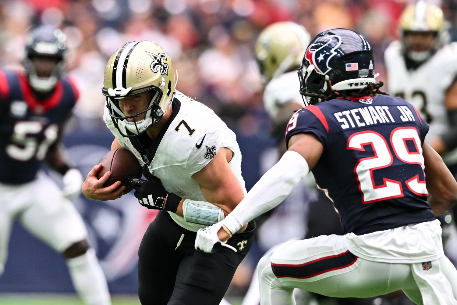 New Orleans Saints quarterback Taysom Hill (7) runs the ball as Houston Texans safety M.J. Stewart (29) defends during the second quarter at NRG Stadium. 